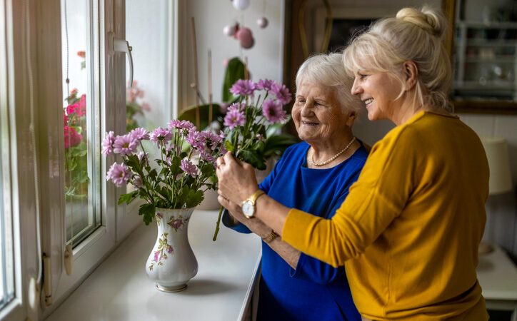 Companion spending time with an older person at home, offering practical and emotional support
