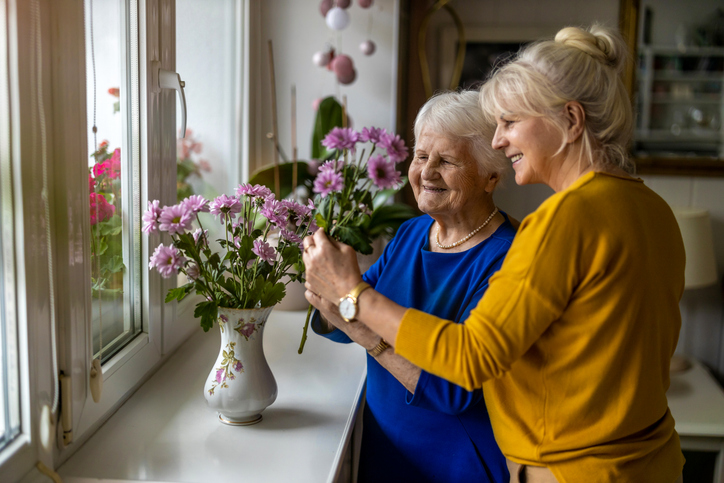 Companion spending time with an older person at home, offering practical and emotional support