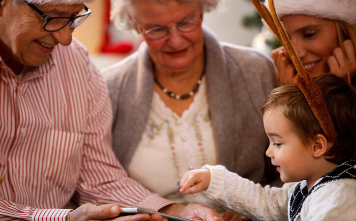 Adult daughter spending time with elderly parent at home after Christmas, talking together